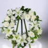 This 18&quot; wreath is created using white roses, lilies, carnations and daisies