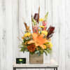 Orange lilies, fall mums and snapdragons glow with the colors of autumn