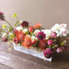 Let this artfully gathered floral centerpiece adorn your table of festivities, celebrating