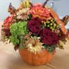 A beautiful centerpiece for your fall decor, this arrangement features a lush