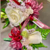 Made from fresh flowers, a corsage looks like a petite flower arrangement
