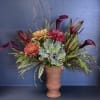 A vividly crafted display, this arrangement uses a beautiful blend of kale
