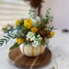 An arrangement inspired by the warmth of autumn, with golden, orange, and