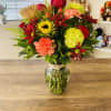 An arrangement with an array of autumn colors arranged in a rose