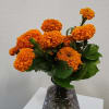 A simple arrangement of marigolds set in a gorgeous keepsake smoke vase