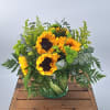 Introducing our cheerful and vibrant flower arrangement featuring sunflowers in a leaf-lined