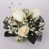 This all white spray roses corsage features spray roses and gems