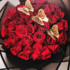Charming arrangement of red roses with butterfly picks.