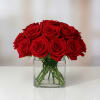 Vibrant Red Roses perfectly arranged in a timeless square glass vase. This