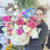 A breathtaking oversized flower basket bursting with dahlias, roses, lisianthus, hydrangea, and