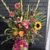 A stunning, one-of-a-kind floral arrangement that radiates elegance and vibrant charm. Designed