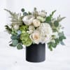 Pearl Essence is a sophisticated floral arrangement that radiates timeless elegance. Featuring
