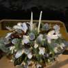 Our lighted winter centerpiece is made of Magnolia leaves, pine cones, and