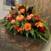 Our beautiful pumpkin centerpiece is made of roses, mini roses, lotus flowers
