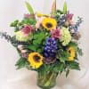 Brighten any space with this vibrant flower arrangement featuring pink lilies, hybrid