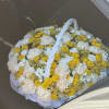 A large basket of yellow and white flowers is not just a