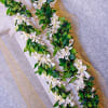 Make an additional statement with a maile highlighted with white orchids throughout.