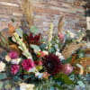 Dark moody hues, mixed with some unexpected pops of color and pampas