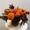 Sure to get you in the Fall spirit, filled with orange roses