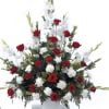 This classic sympathy piece feature glads, roses and carnations.