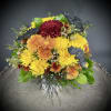 A whimsical floral arrangement bursts from a keepsake (and reusable) coffee mug