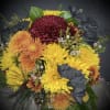 A whimsical floral arrangement bursts from a keepsake (and reusable) coffee mug