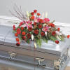This casket spray features red roses, lilys, carnations and gerbers. Such a