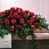 This casket spray features all red roses.