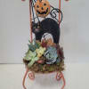 A decorative metal chair planted much in the same manner as our