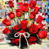 Beautiful floral arrangement with red roses on a coquette-style ceramic base, ideal