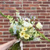 A beautifully wrapped bouquet with a selection of simple &amp; soft blooms