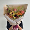 A rustic autumn mix bouquet featuring sunflowers, roses, and cozy seasonal tones.

Flower