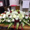 The Eternal Rest Casket Spray is created with a hint of red