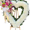 A tender expression if love and remembrance, this heart shaped floral arrangement