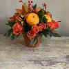A beautiful fall arrangement in a rustic Terra cotta container 