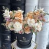 A soft and elegant arrangement in our signature box. Delicate roses in