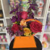 fresh flowers in orange purse setting 