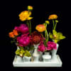 Placed in a multi-vase container with bright florals sure to put a