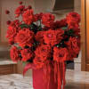 Indulge in the beauty of opulent red roses, meticulously arranged in a