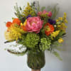 Season summer flowers arranged into a vase. 