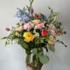Seasonal mixed flowers arranged into a vase. 