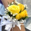 Bright yellow roses paired with delicate baby&rsquo;s breath and a crisp white