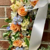 This fresh wreath arrangement has an elegant garden style look that can