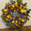This fresh wreath arrangement has an elegant garden style look that can