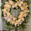 This fresh heart shaped wreath arrangement has an elegant garden style look