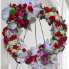 Beating Memorial wreath adorned with baby&#039;s breath Red and pink roses, red
