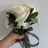 This cute bouquet features 3 white roses, babies breath and greenery. You