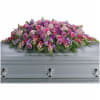Like a heartfelt embrace, this beautiful casket spray extraordinarily delivers comfort and