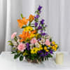 A lively basket of orange lilies, purple bellflowers, pink carnations, yellow daisies