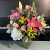 A bright and colorful arrangement mixed with the freshest of flowers. These